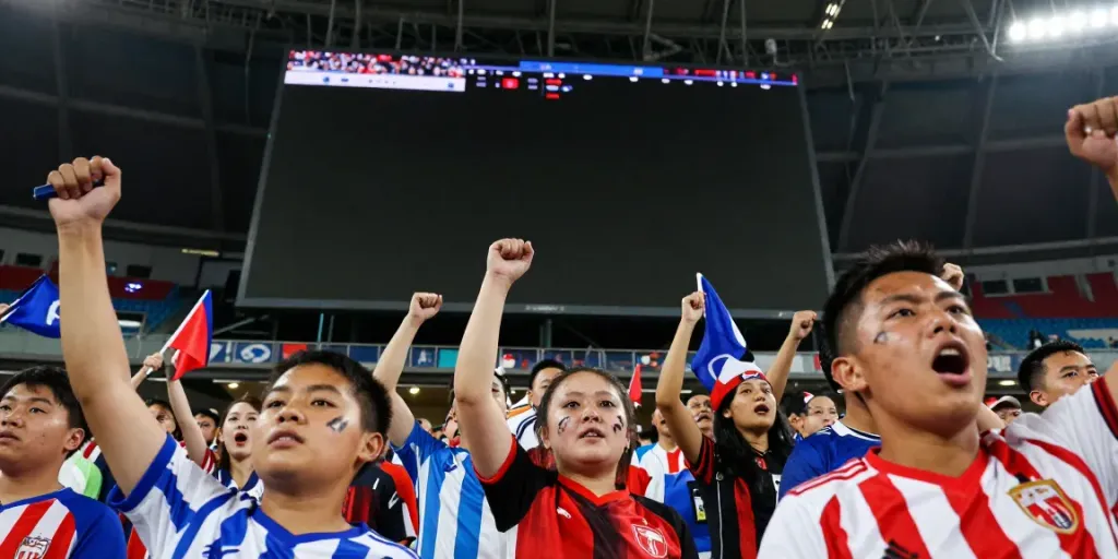 Excited soccer fans cheering during a live match at GangvangTV event.